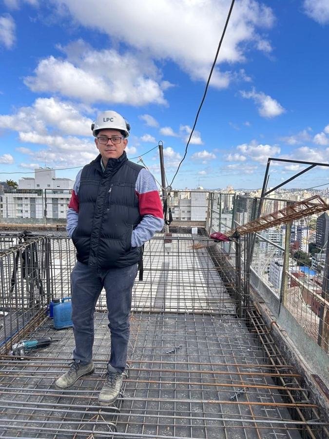 Leandro Campos em laje de edifício em construção, com capacete da LPC